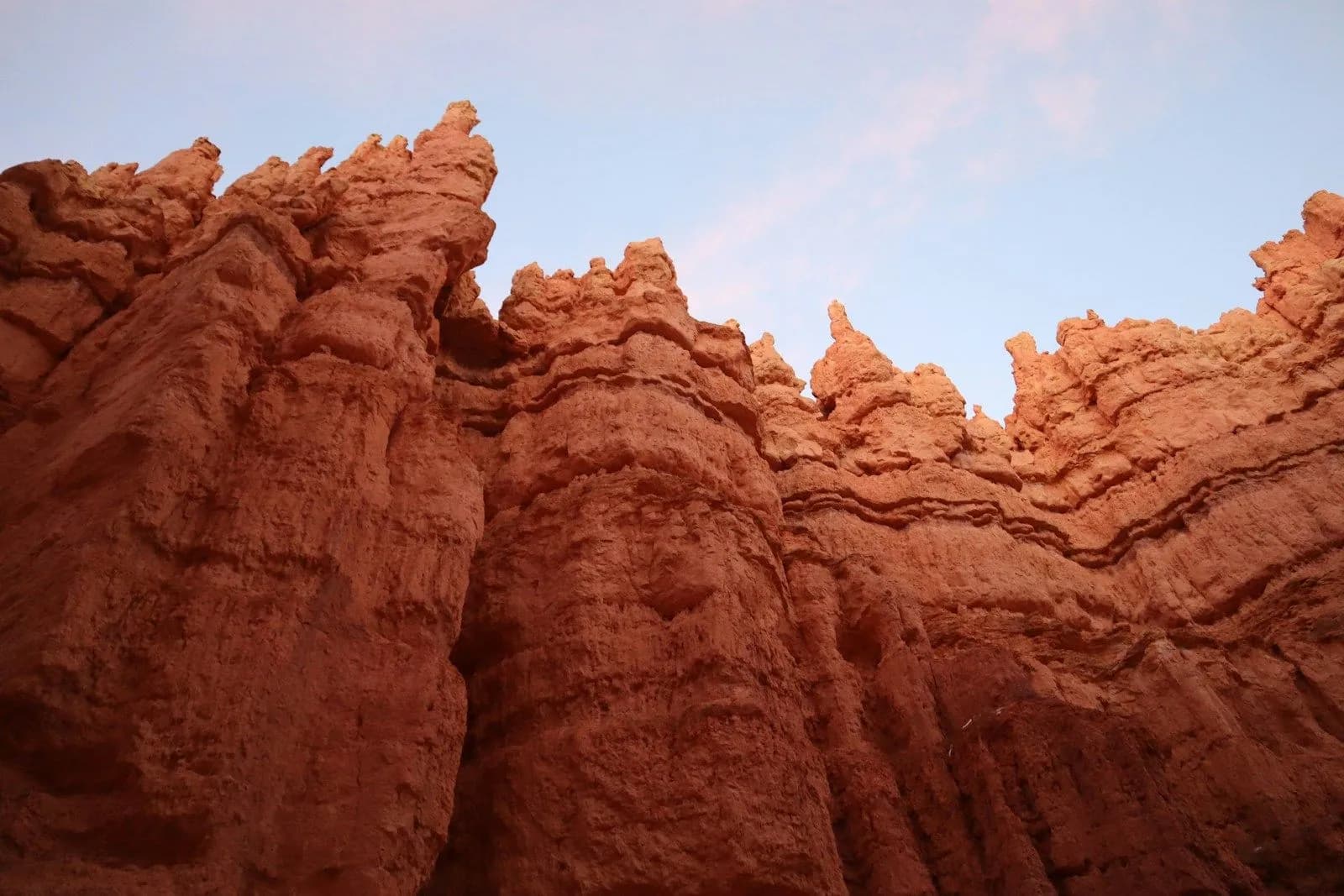 brown rock formation under white clouds during daytime